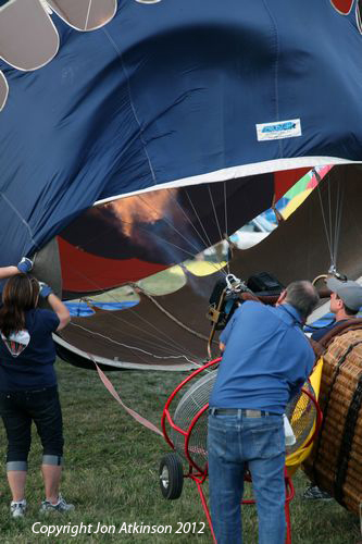 Pilot starts to inflate the ballon with hot air before launching.